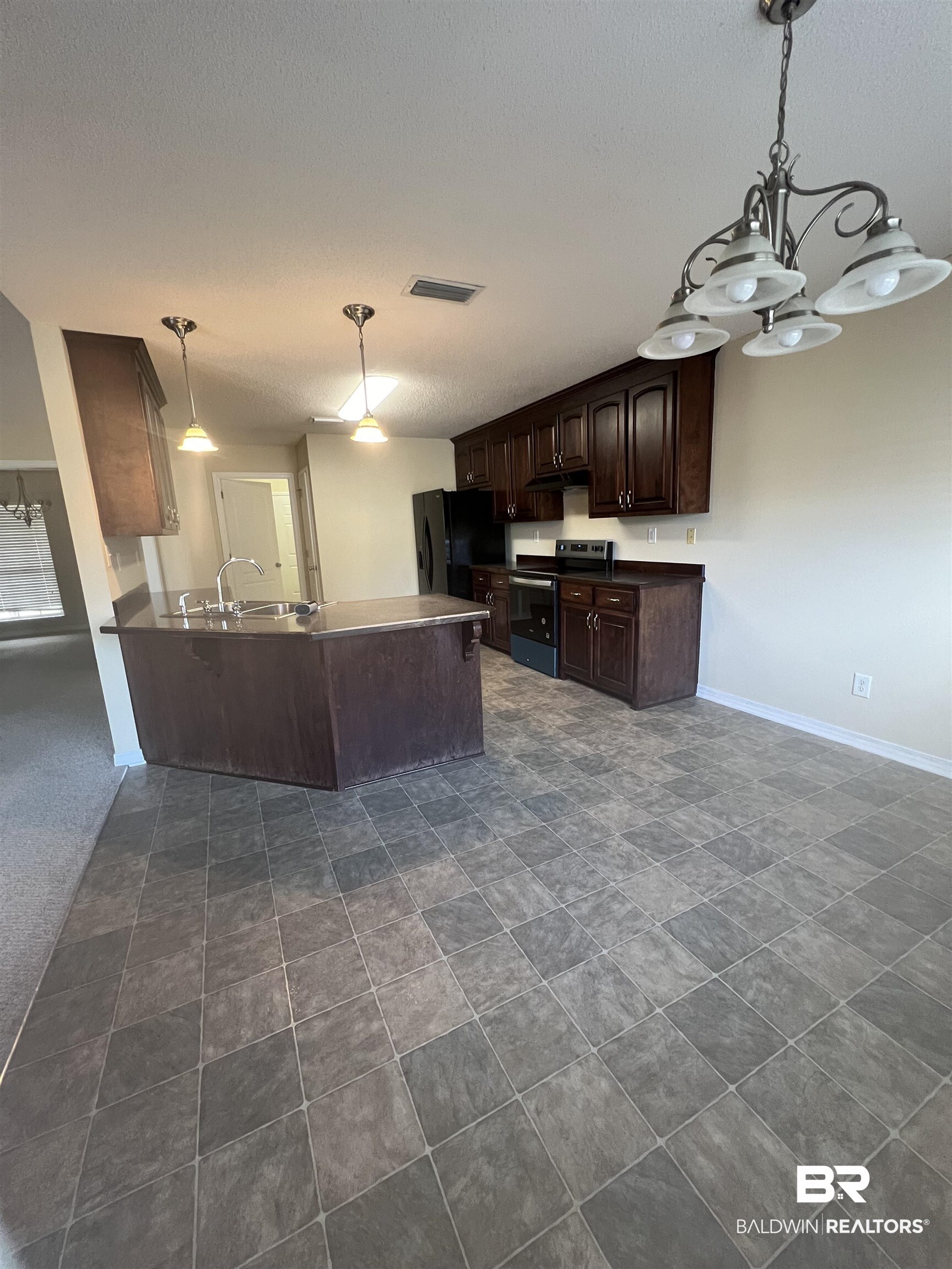 17793 Fancy Boulevard Foley, AL 36535 - Photo 33 of 34 Kitchen featuring stainless steel electric range oven, decorative light fixtures, dark brown cabinetry, kitchen peninsula, and black refrigerator with ice dispenser