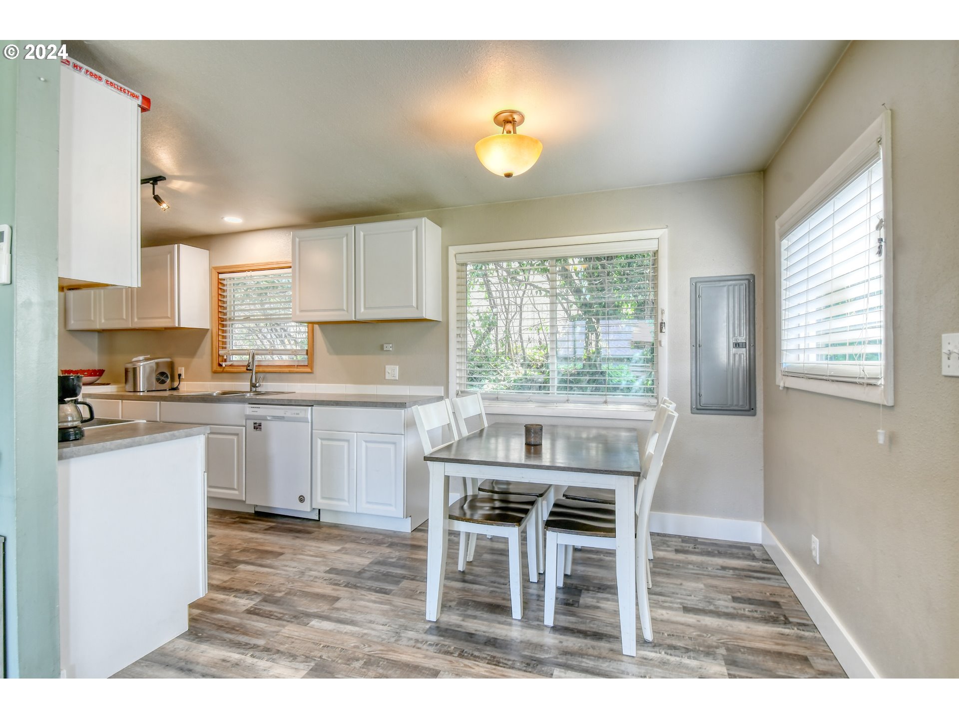 824 Southwest 8th Street Pendleton, OR 97801 - Photo 15 of 28 a kitchen with a table chairs a sink dishwasher window and cabinets