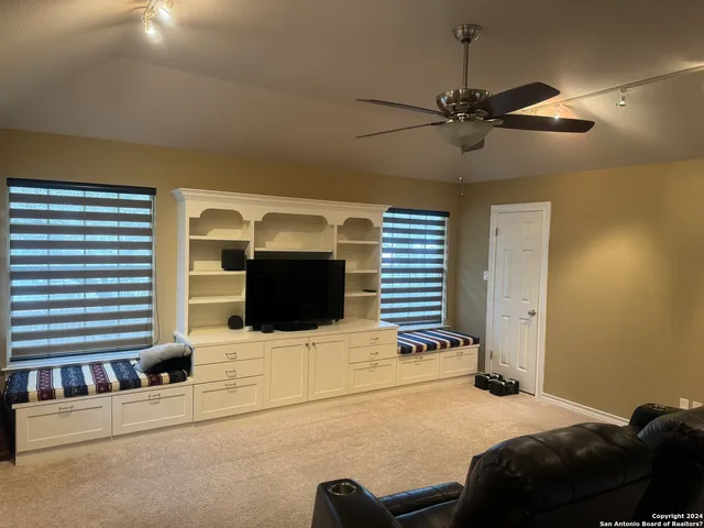 a bedroom with a bed dresser and a flat screen tv