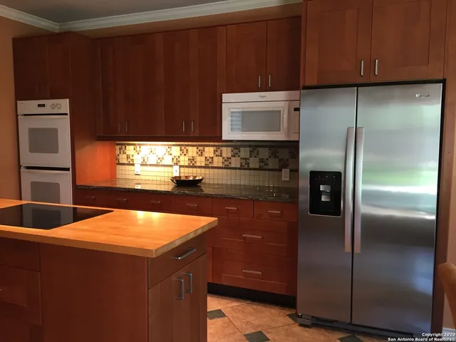 a kitchen with stainless steel appliances a refrigerator and a sink