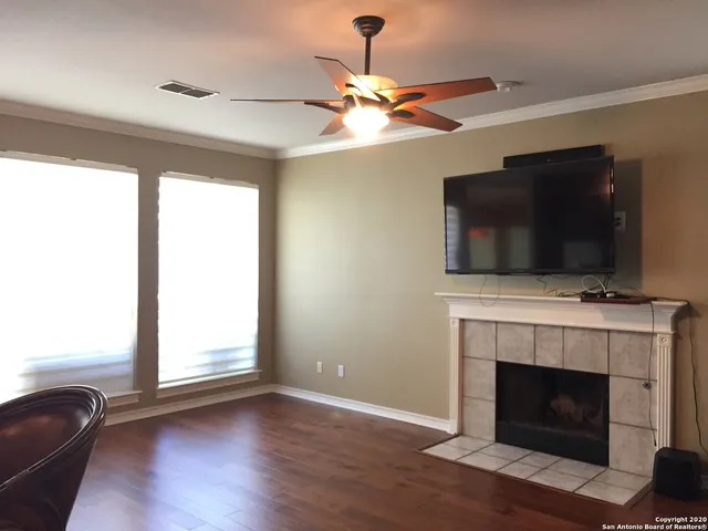 a living room with flat screen tv and a fireplace
