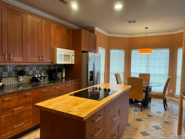 a kitchen with a sink cabinets and dining table