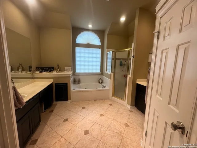 a bathroom with a sink a toilet a mirror and a tub