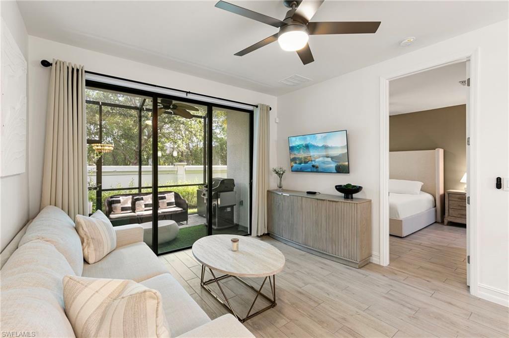 7622 Rockefeller Drive Naples, FL 34119 - Photo 11 of 35 a living room with furniture and a large window