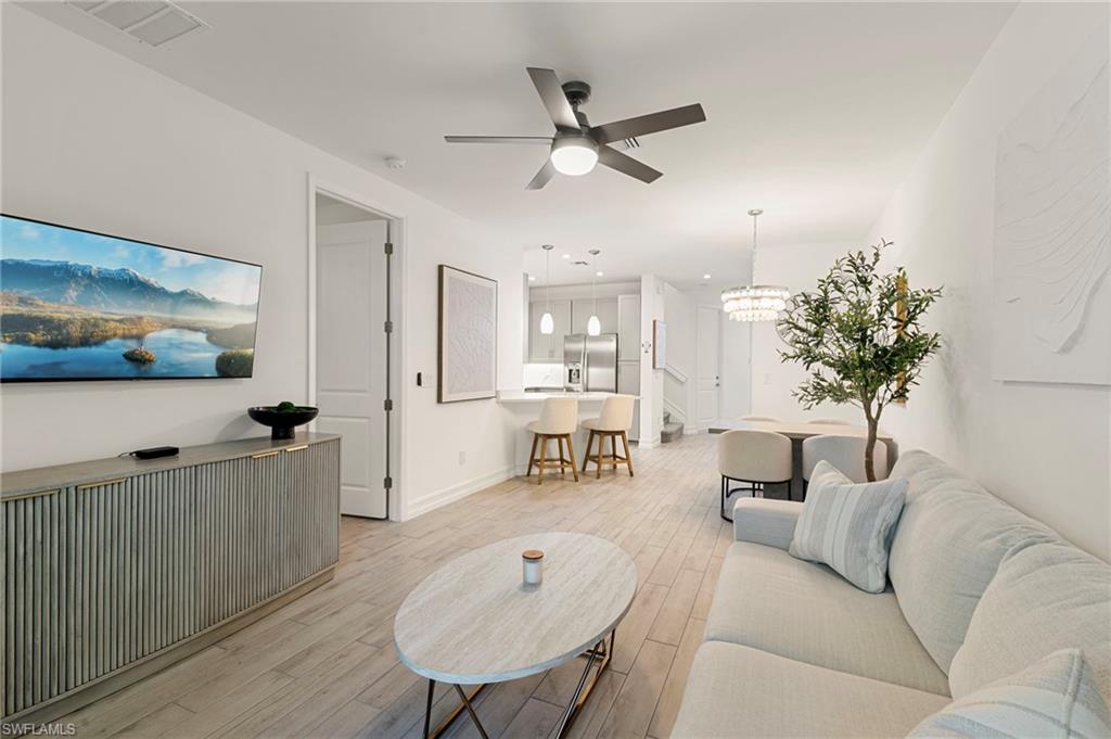 7622 Rockefeller Drive Naples, FL 34119 - Photo 12 of 35 a living room with furniture and a table