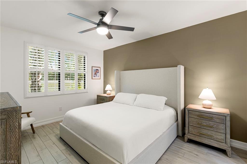 7622 Rockefeller Drive Naples, FL 34119 - Photo 17 of 35 a bedroom with a bed and a window