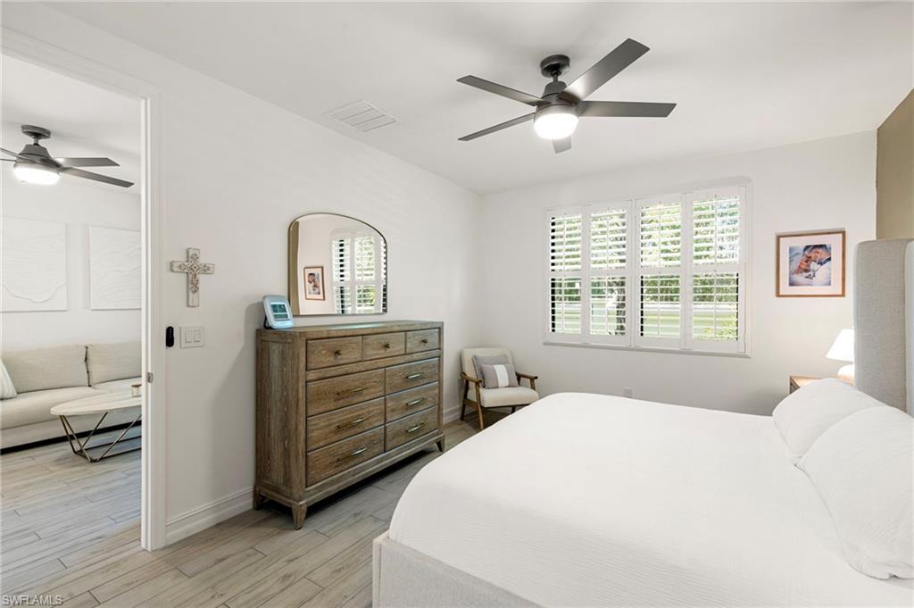 7622 Rockefeller Drive Naples, FL 34119 - Photo 18 of 35 a bedroom with a bed and a dresser