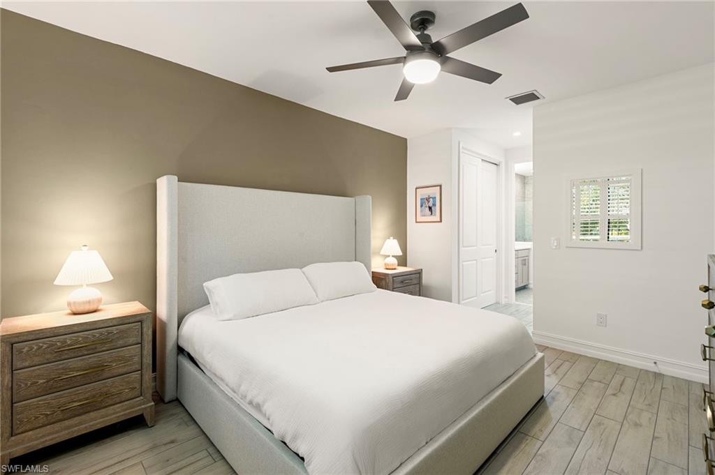 7622 Rockefeller Drive Naples, FL 34119 - Photo 19 of 35 a bedroom with a bed and a ceiling fan