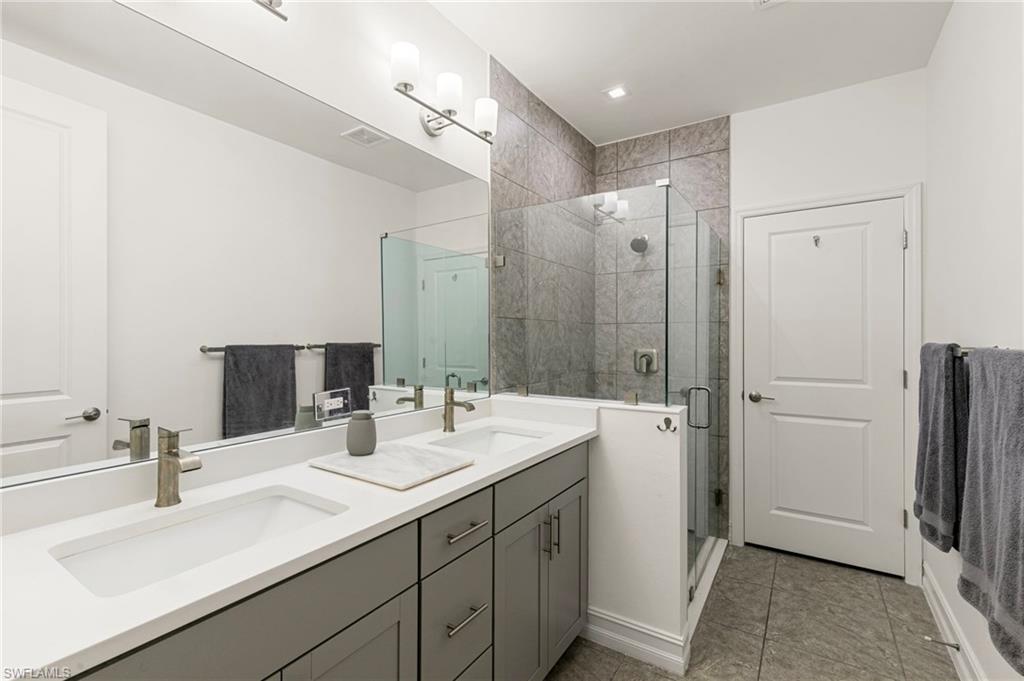 7622 Rockefeller Drive Naples, FL 34119 - Photo 20 of 35 a bathroom with a double vanity sink mirror and double