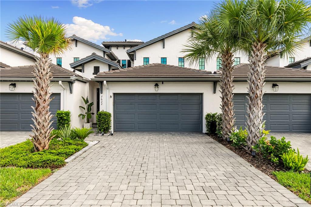 7622 Rockefeller Drive Naples, FL 34119 - Photo 2 of 35 a front view of a house with a garden