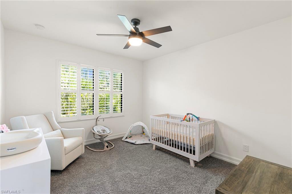 7622 Rockefeller Drive Naples, FL 34119 - Photo 22 of 35 a living room with furniture and a large window