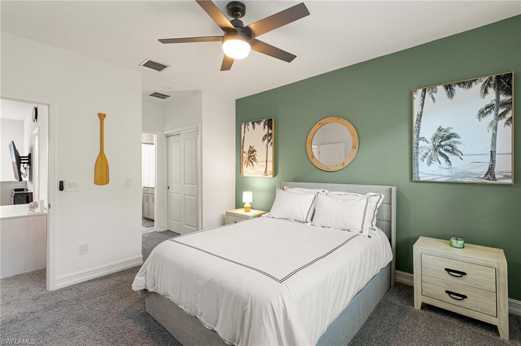 7622 Rockefeller Drive Naples, FL 34119 - Photo 23 of 35 a bedroom with a bed and a painting on the wall