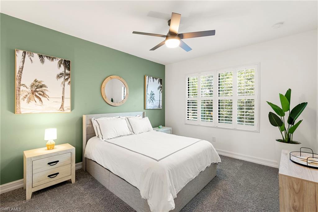 7622 Rockefeller Drive Naples, FL 34119 - Photo 24 of 35 a bedroom with a bed and a painting on the wall