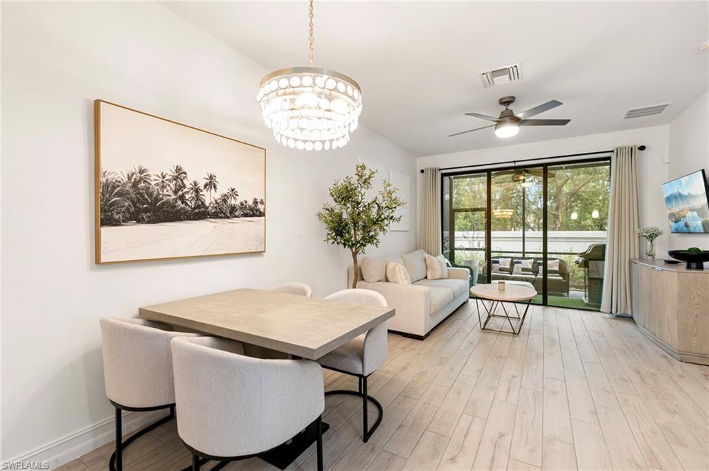 7622 Rockefeller Drive Naples, FL 34119 - Photo 7 of 35 a view of a dining room with furniture wooden floor and chandelier