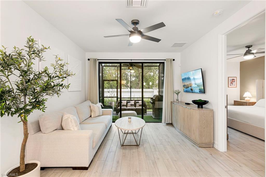 7622 Rockefeller Drive Naples, FL 34119 - Photo 8 of 35 a living room with furniture and a large window with wooden floor