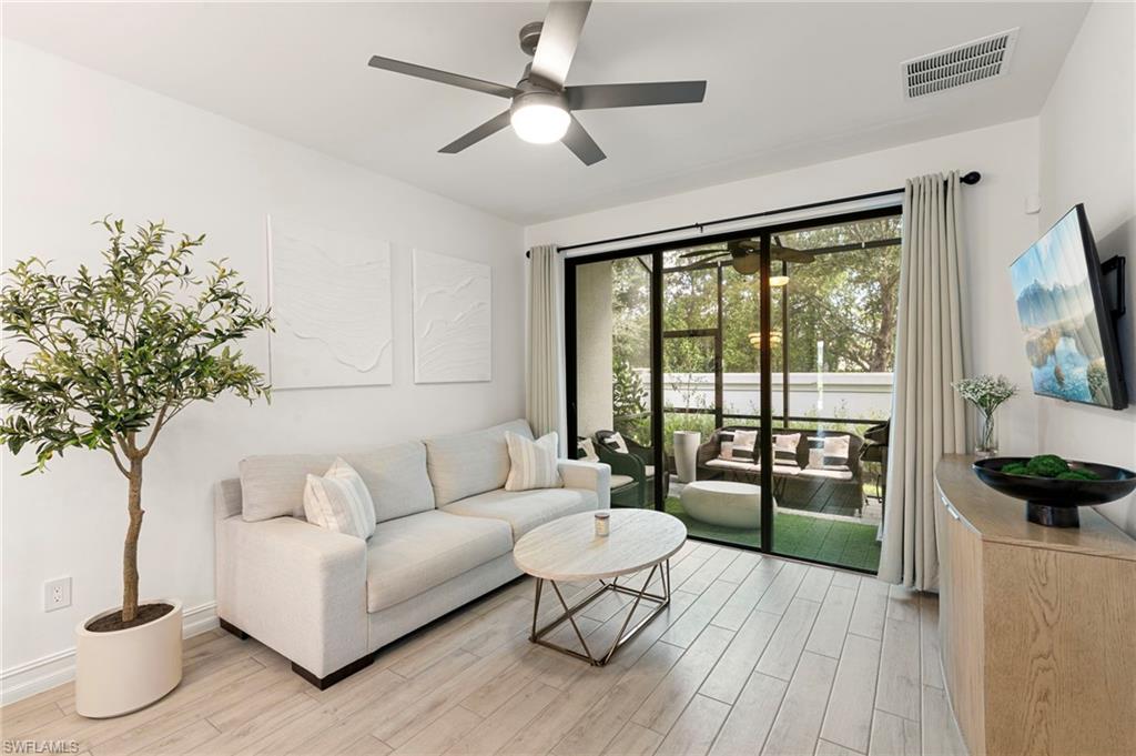 7622 Rockefeller Drive Naples, FL 34119 - Photo 10 of 35 a living room with furniture and a large window