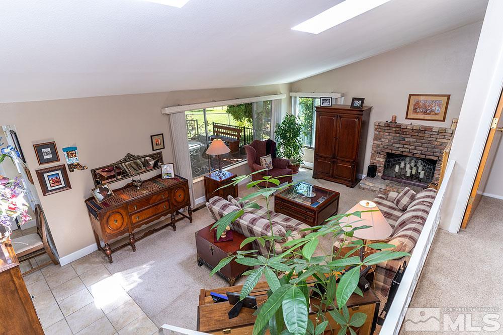 11325 Maverick Lane Reno, NV 89511 - Photo 3 of 20 a living room with furniture a window and a flat screen tv