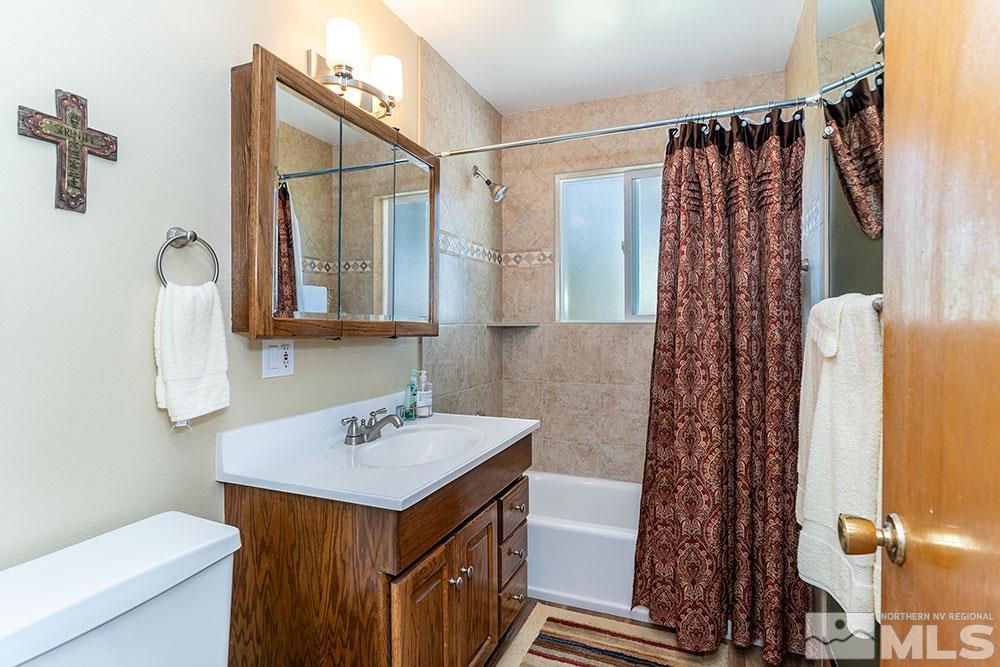 11325 Maverick Lane Reno, NV 89511 - Photo 8 of 20 a bathroom with a sink a toilet and shower