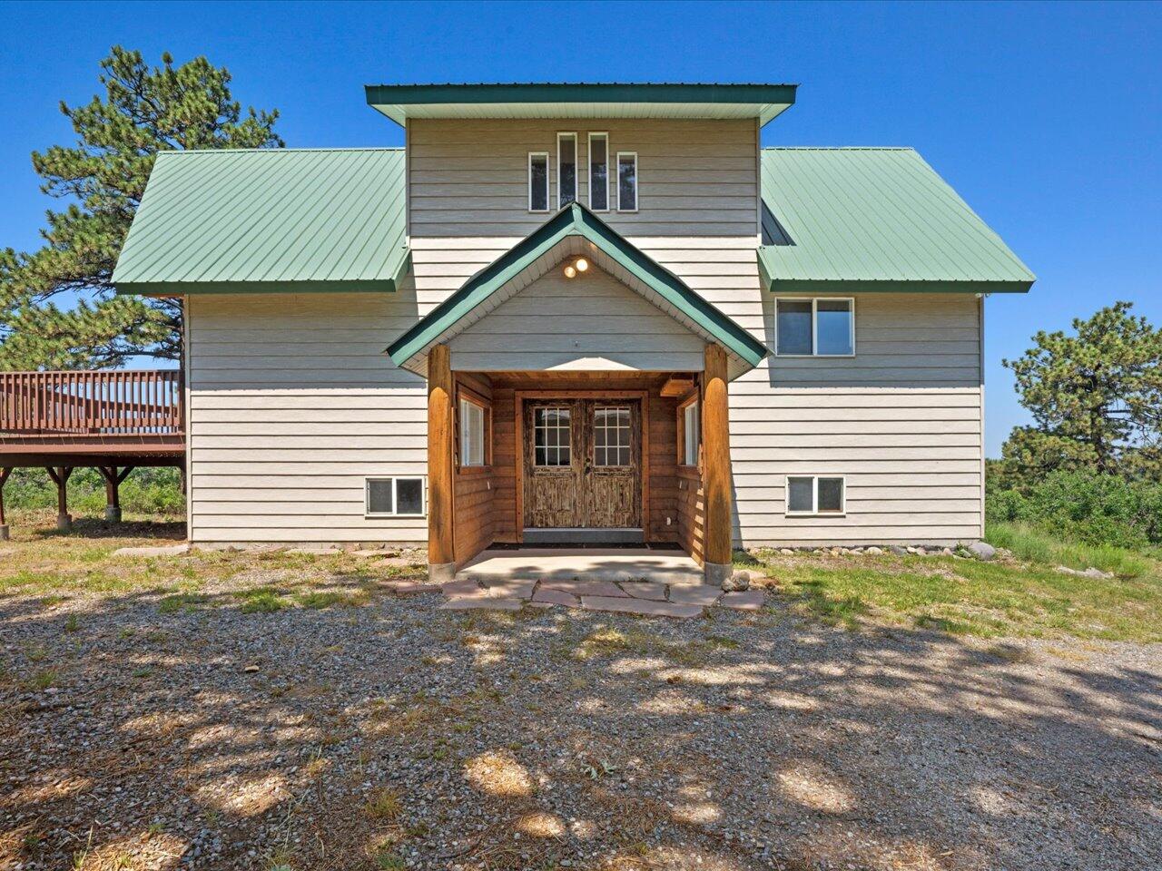 55 Valley View Road Ridgway, CO 81432 - Photo 1 of 39 a front view of a house with a yard and garage