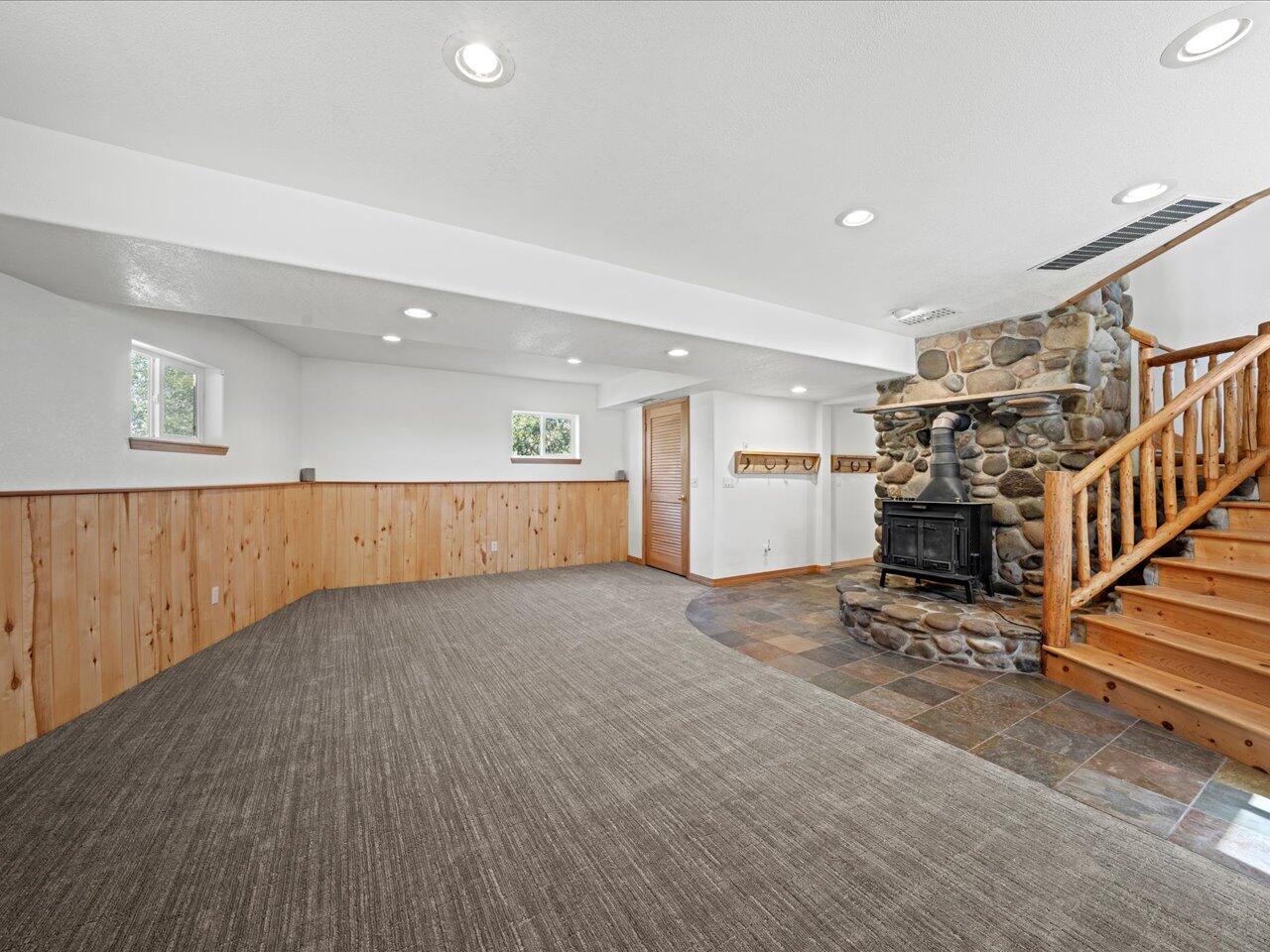 55 Valley View Road Ridgway, CO 81432 - Photo 20 of 39 an empty room with wooden floor and a fireplace