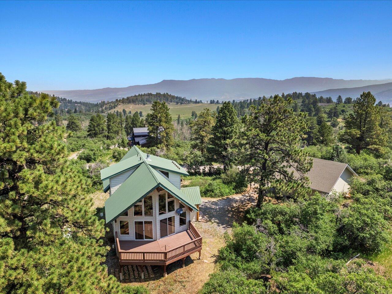 55 Valley View Road Ridgway, CO 81432 - Photo 2 of 39 a view of a house with a mountain in the background