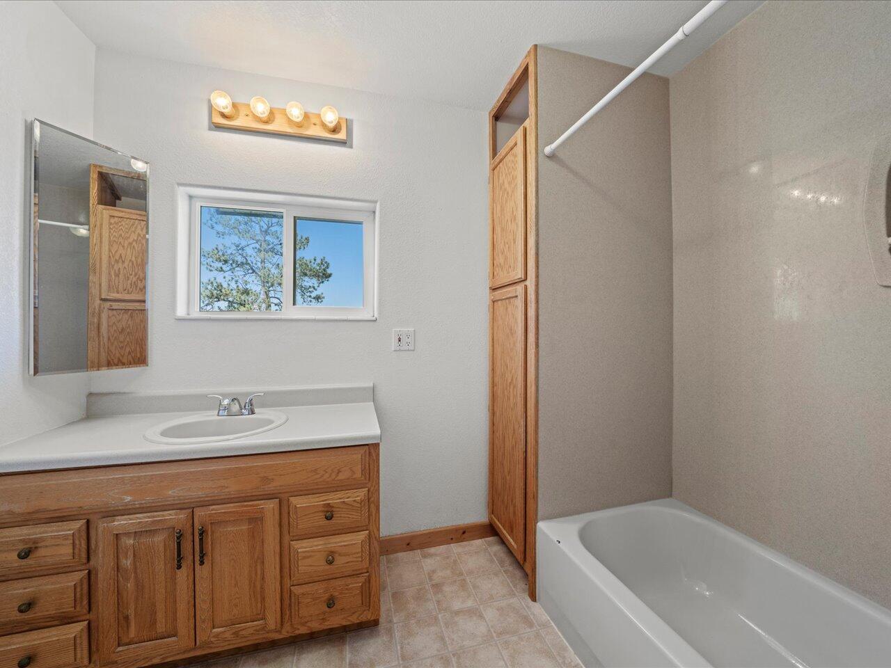 55 Valley View Road Ridgway, CO 81432 - Photo 26 of 39 a bathroom with a tub sink and mirror