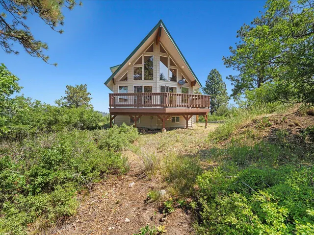 a front view of a house with a yard and balcony