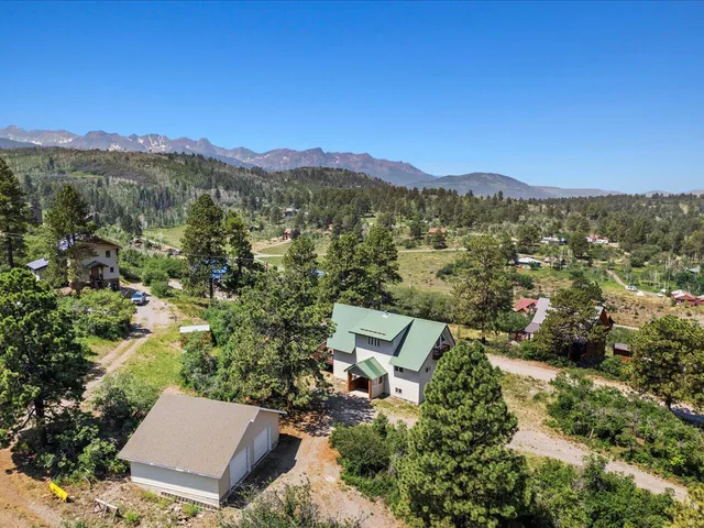 an aerial view of a house with a yard