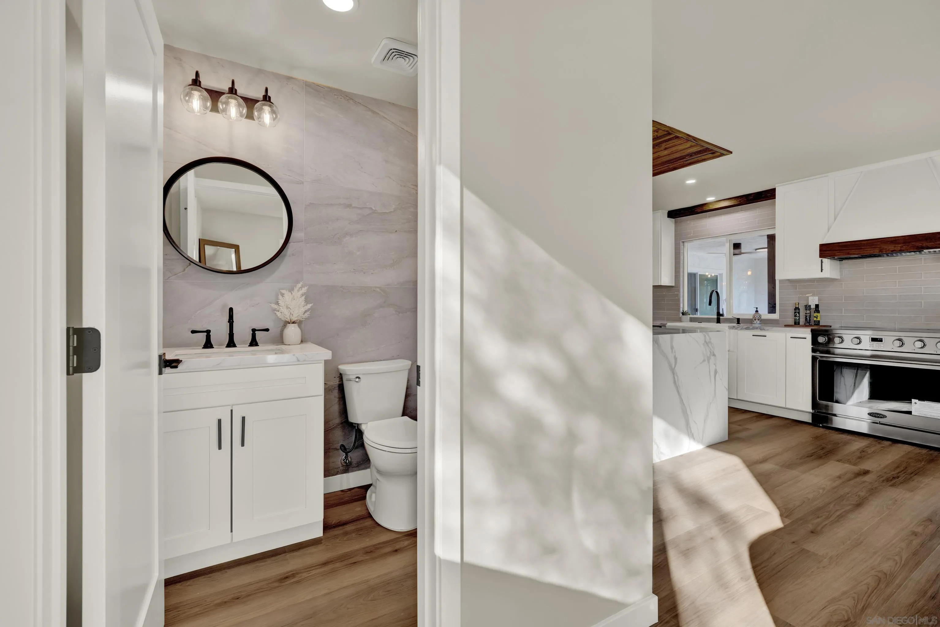 14407 Mountain Road Poway, CA 92064 - Photo 29 of 75 a en suite bathroom with a double vanity sink and a mirror