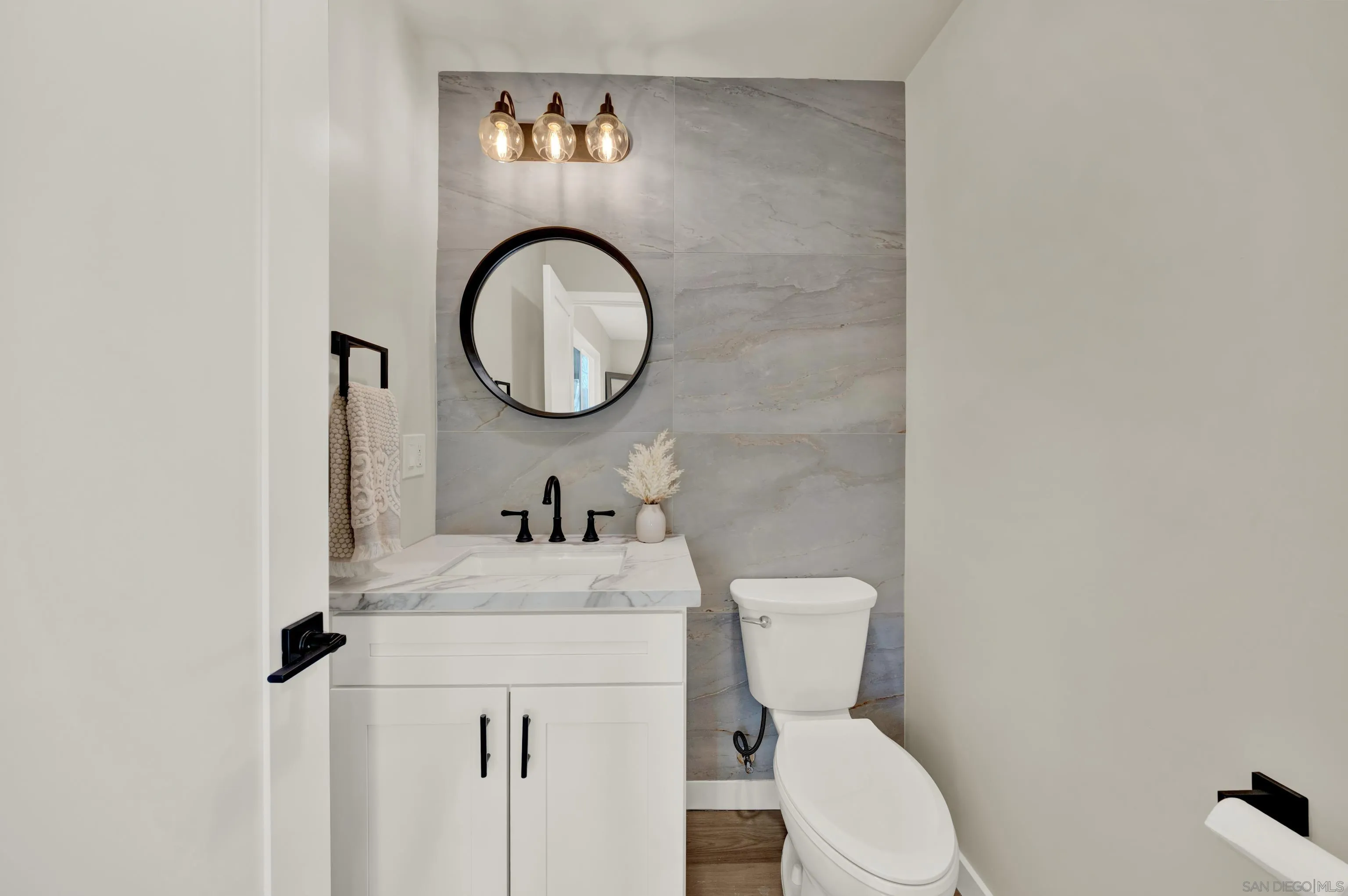 14407 Mountain Road Poway, CA 92064 - Photo 30 of 75 a bathroom with a toilet a sink and a mirror