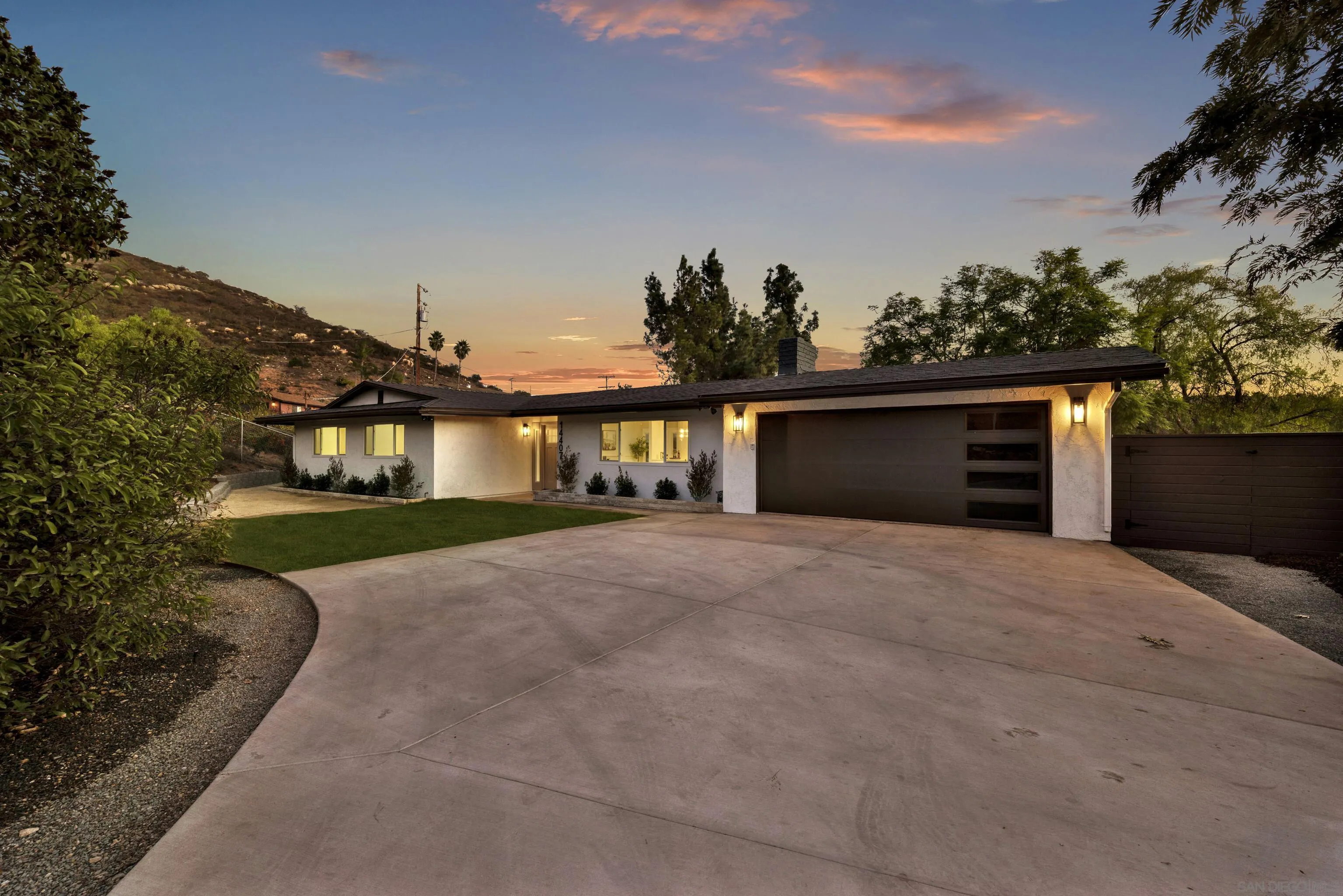 14407 Mountain Road Poway, CA 92064 - Photo 3 of 75 a front view of a house with a yard and garage