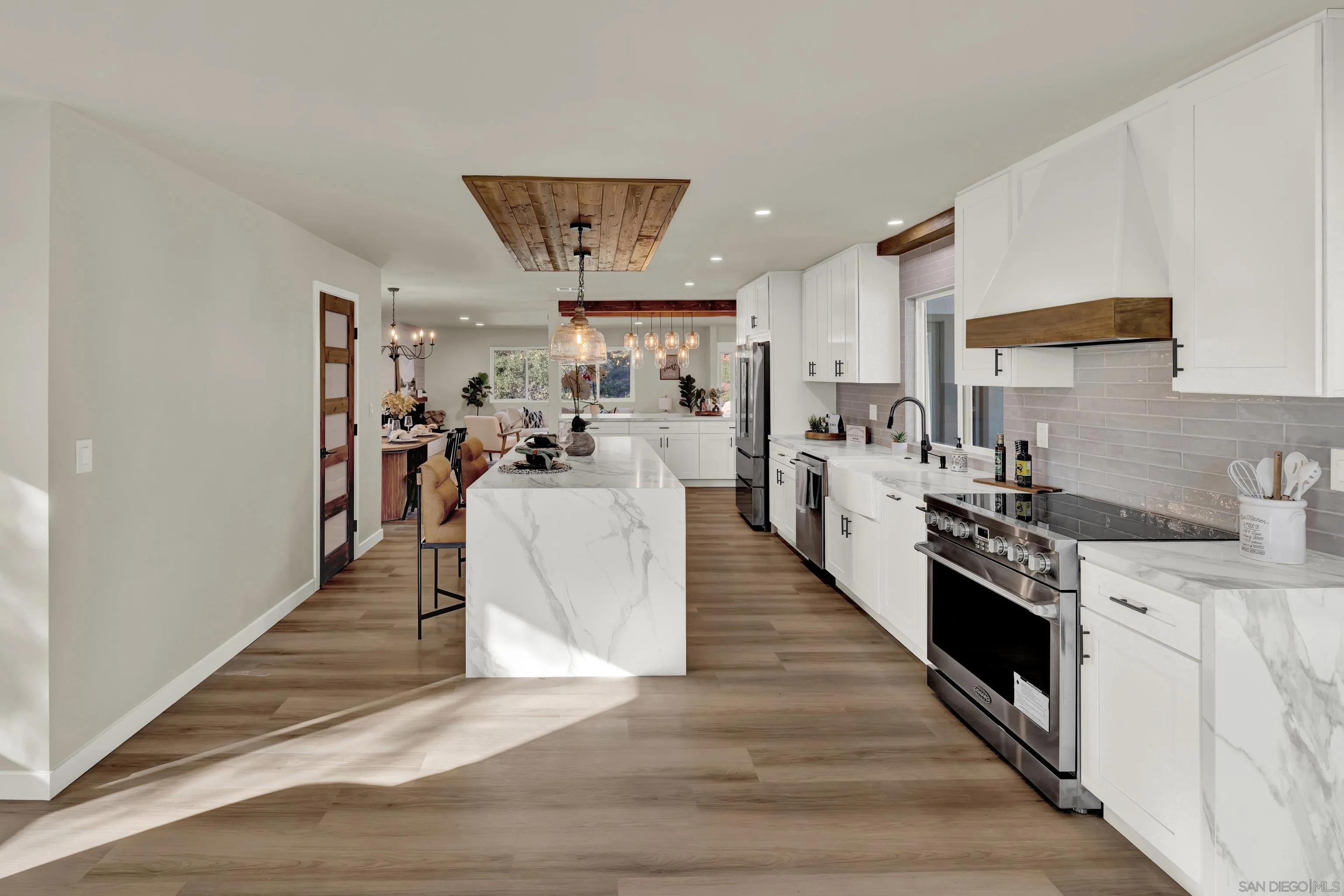 14407 Mountain Road Poway, CA 92064 - Photo 32 of 75 a view of a kitchen with kitchen island stainless steel appliances a counter top space cabinets and a center island