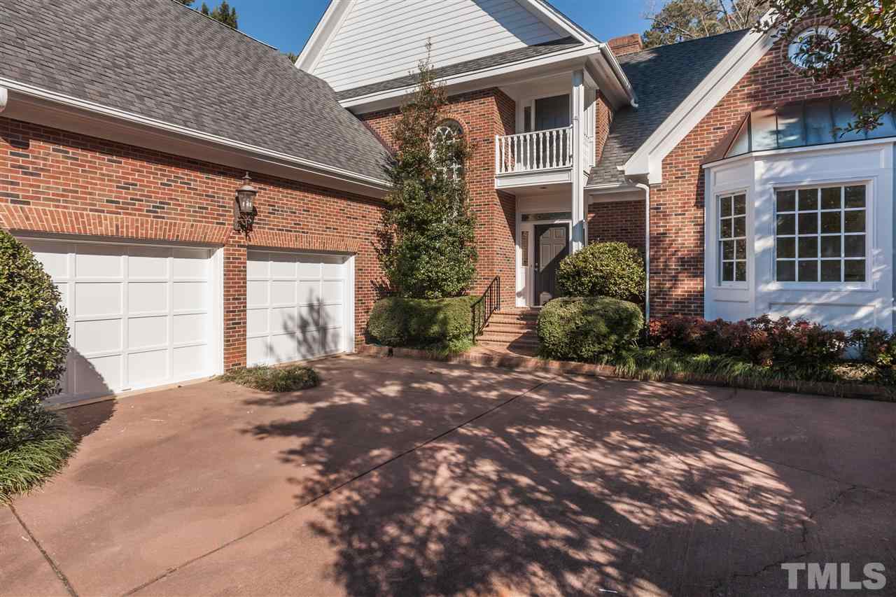 2008 Tradd Court Raleigh, NC 27607 - Photo 2 of 25 a front view of a house with garden