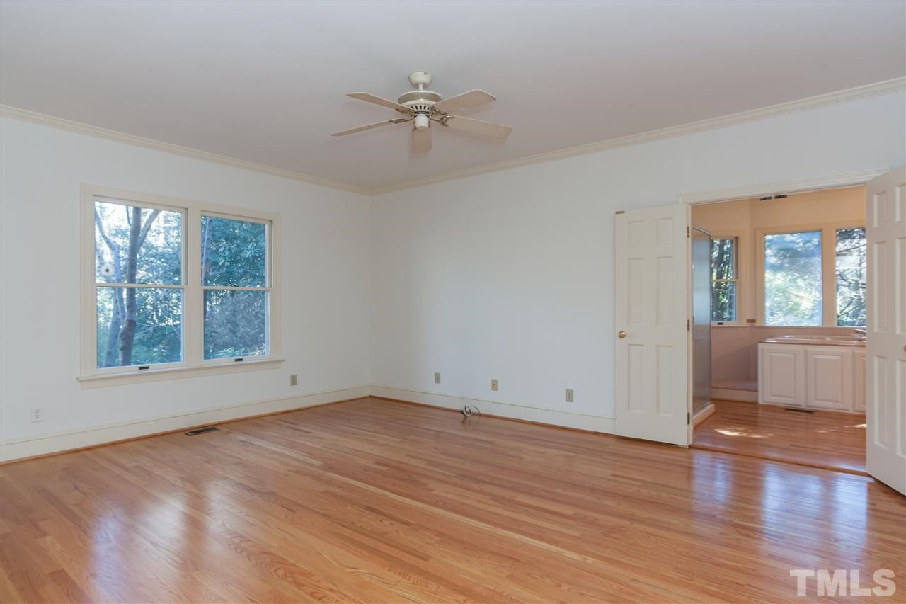 2008 Tradd Court Raleigh, NC 27607 - Photo 11 of 25 a view of an empty room with wooden floor and a window
