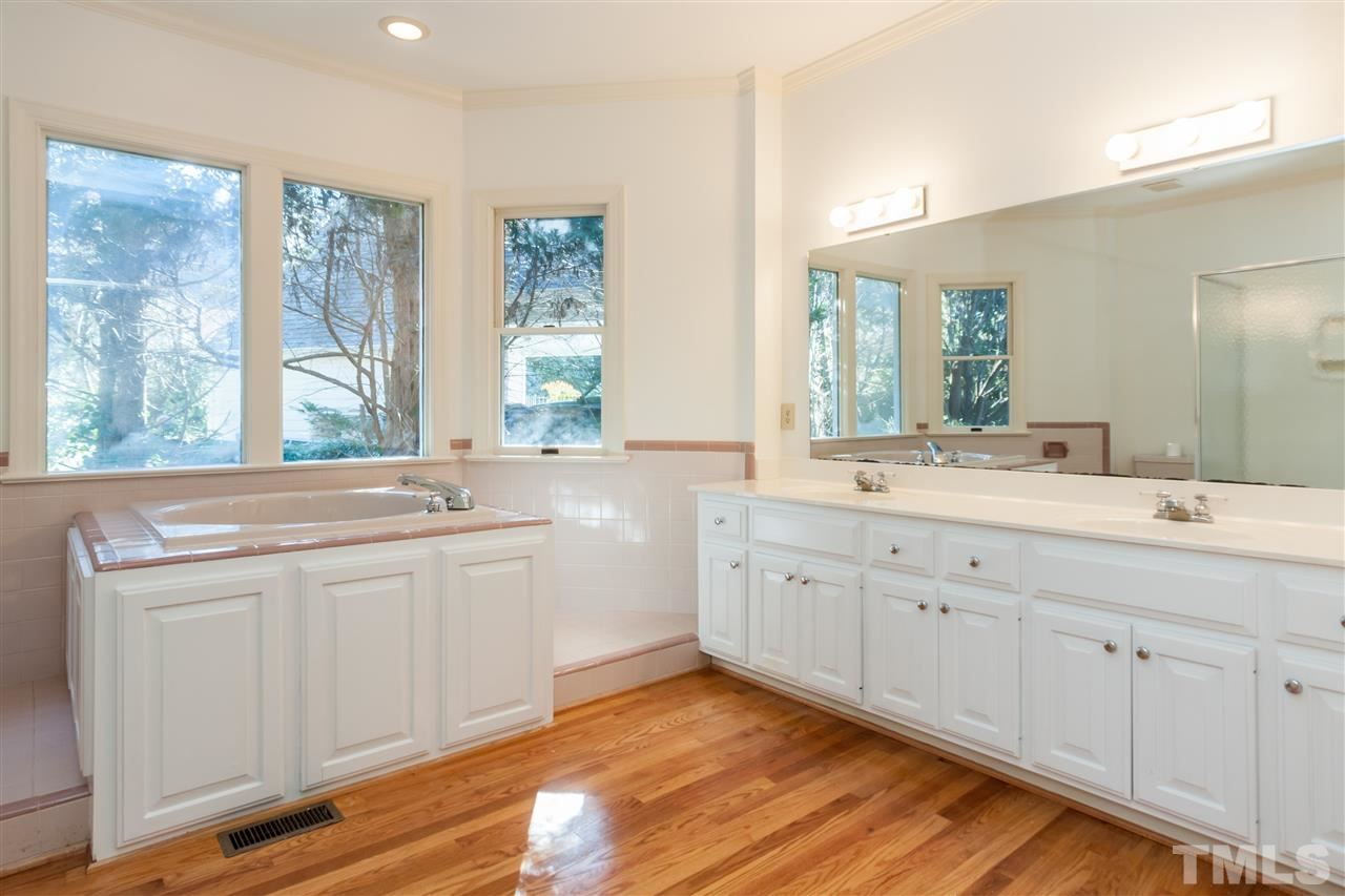 2008 Tradd Court Raleigh, NC 27607 - Photo 12 of 25 a spacious bathroom with double vanity and a large mirror