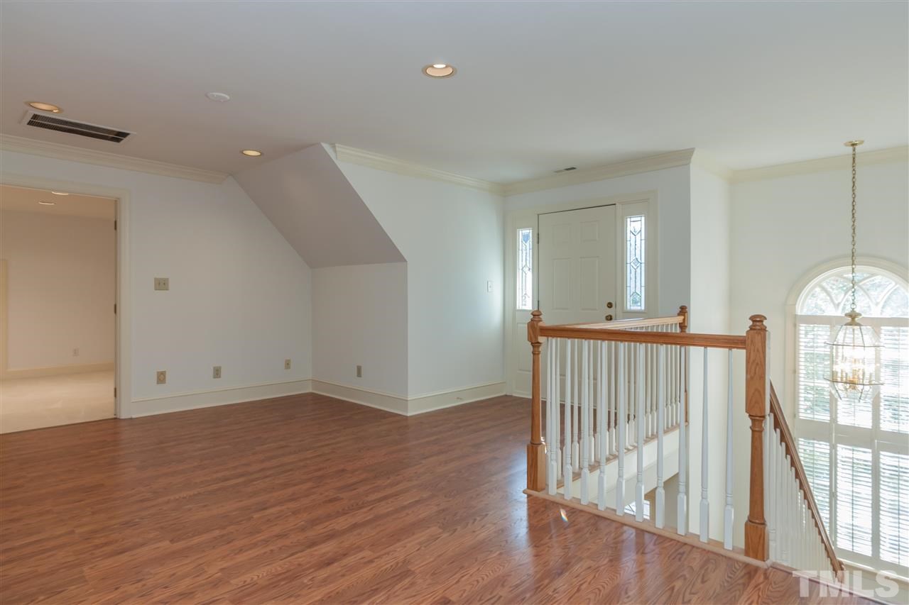 2008 Tradd Court Raleigh, NC 27607 - Photo 15 of 25 an empty room with wooden floor and windows