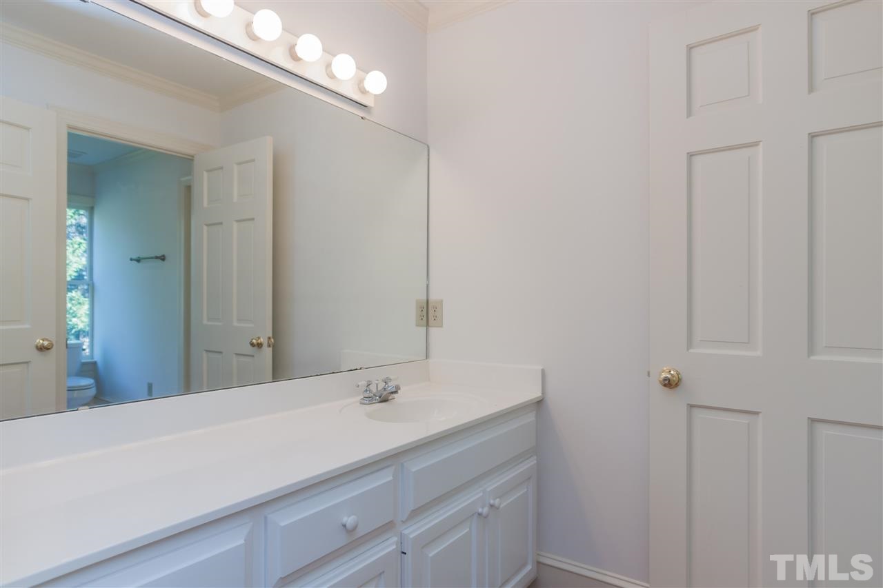 2008 Tradd Court Raleigh, NC 27607 - Photo 17 of 25 a bathroom with a sink vanity and a mirror