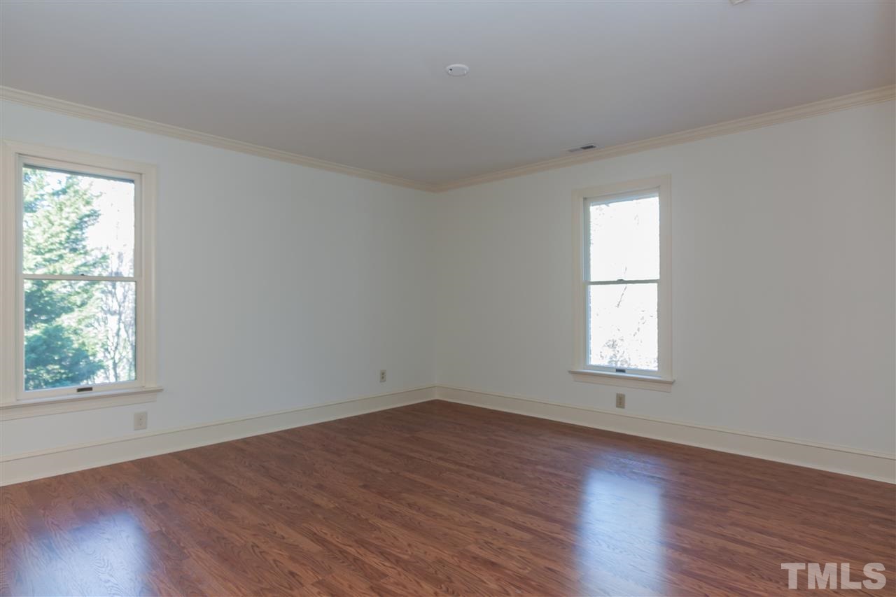 2008 Tradd Court Raleigh, NC 27607 - Photo 18 of 25 an empty room with wooden floor and windows