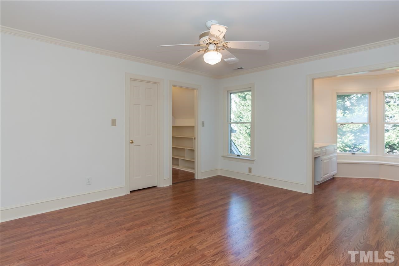 2008 Tradd Court Raleigh, NC 27607 - Photo 20 of 25 a view of an empty room with wooden floor and a window