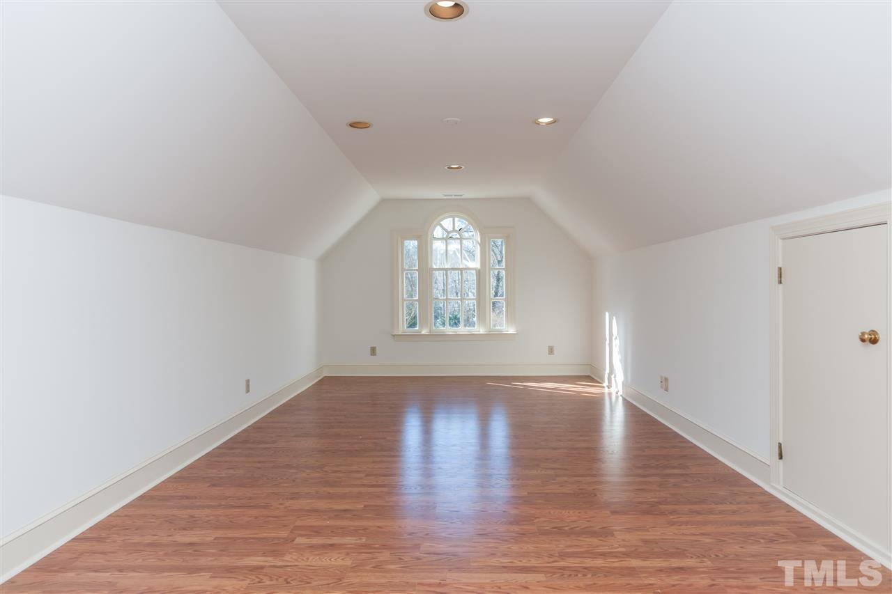 2008 Tradd Court Raleigh, NC 27607 - Photo 21 of 25 an empty room with wooden floor and windows
