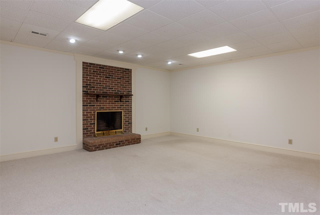 2008 Tradd Court Raleigh, NC 27607 - Photo 22 of 25 an empty room with a fireplace