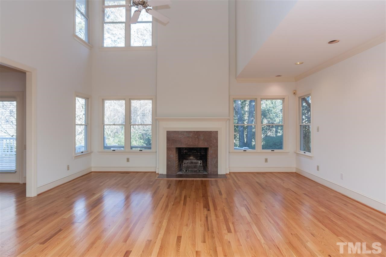 2008 Tradd Court Raleigh, NC 27607 - Photo 4 of 25 wooden floor fireplace and windows in an empty room