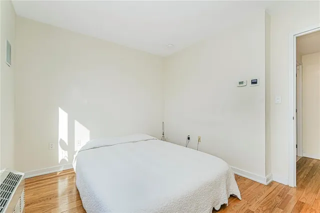 a bed sitting in a bedroom next to a window