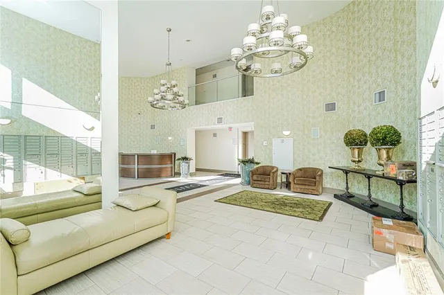 a living room with fireplace furniture and a chandelier