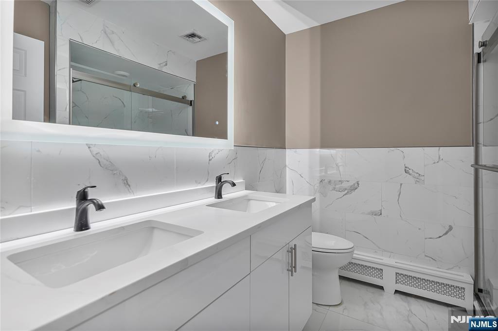 75 West Columbia Avenue, Unit 2 Palisades Park, NJ 07650 - Photo 11 of 27 a bathroom with a sink and a toilet