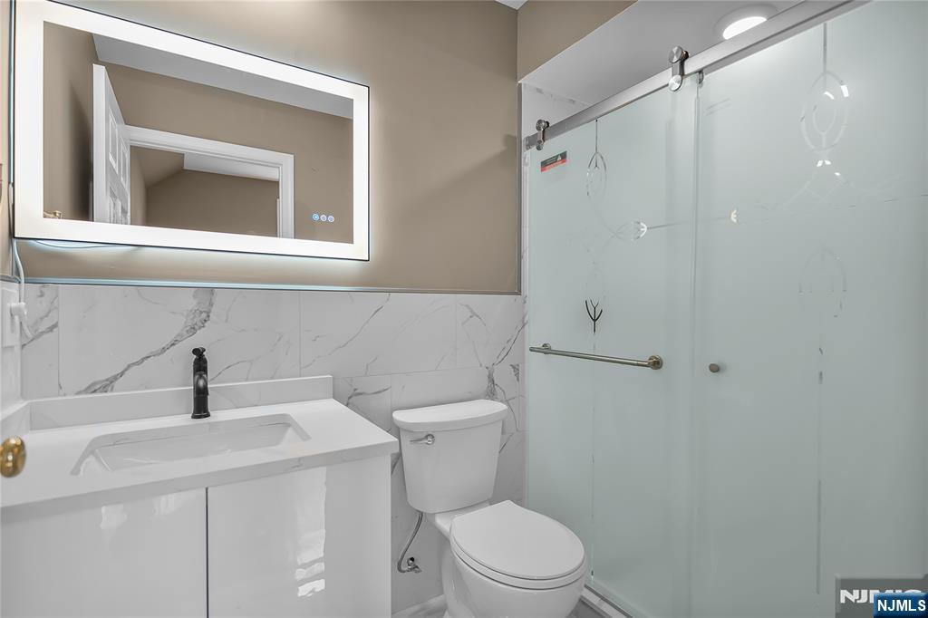 75 West Columbia Avenue, Unit 2 Palisades Park, NJ 07650 - Photo 17 of 27 a bathroom with a sink a toilet and shower