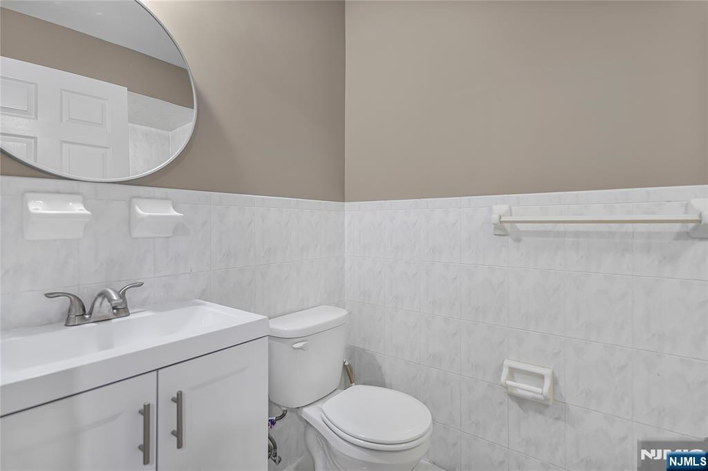 75 West Columbia Avenue, Unit 2 Palisades Park, NJ 07650 - Photo 21 of 27 a bathroom with a sink a toilet and vanity