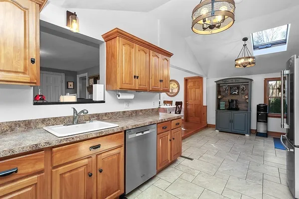 a kitchen with stainless steel appliances granite countertop a sink and a cabinets