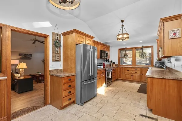 a kitchen with stainless steel appliances granite countertop a refrigerator and a sink