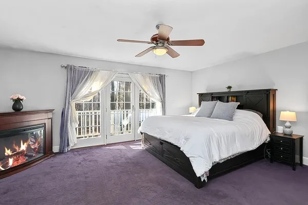 a spacious bedroom with a bed and a fireplace